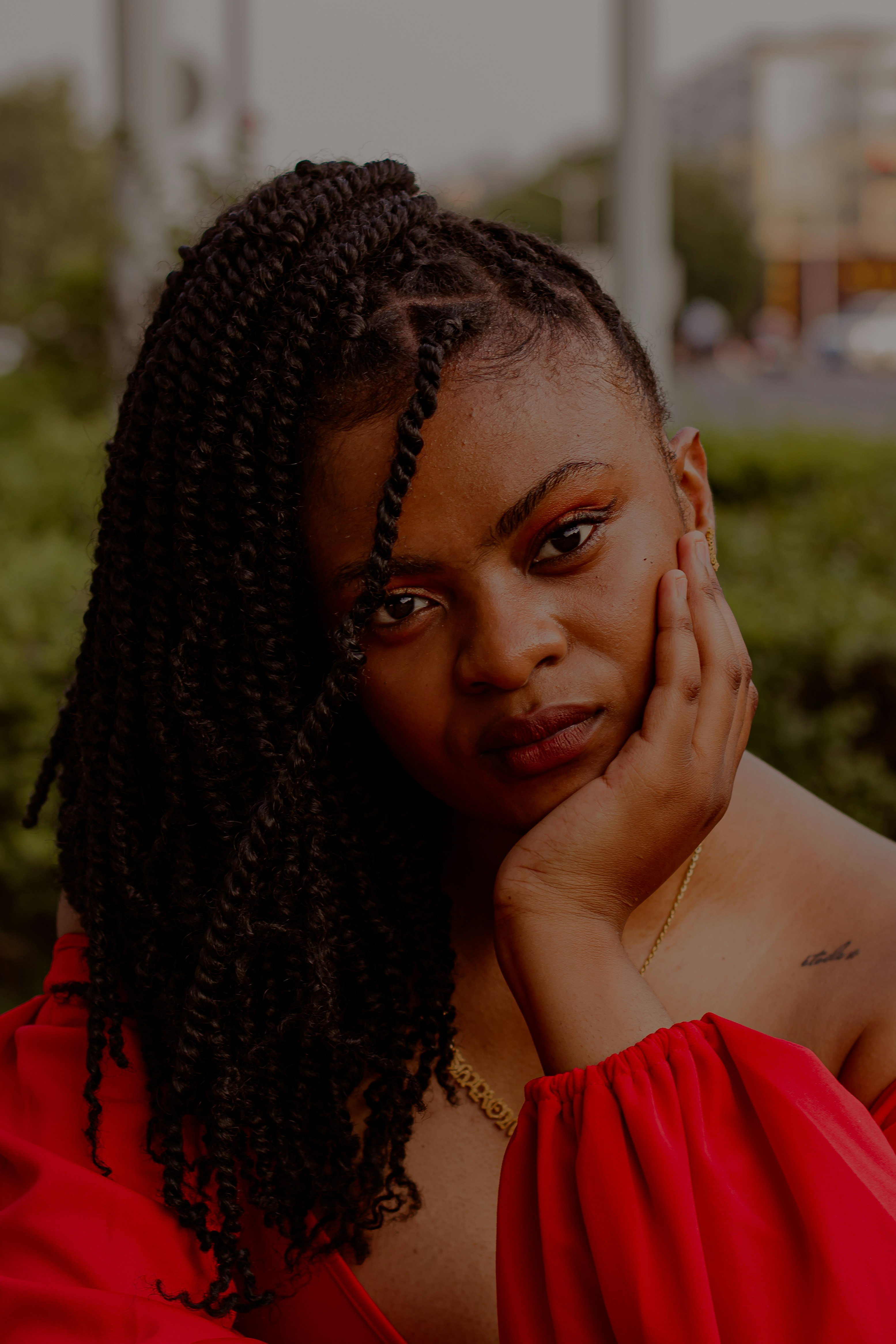 woman in red shirt with braided hair